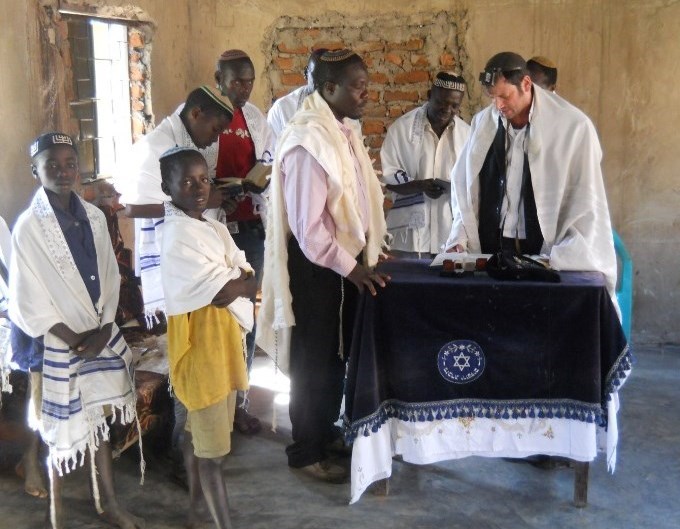 The Abayudaya at prayer in their synagogue in Puti next to Mbale. A visiting rabbi joins them. 
