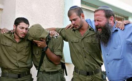 IDF Soldiers sent to evacuate all Israeli residents from Gaza in August 2005, cry with a resident as a synagogue is dismantled. 