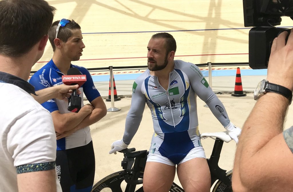 Journalists interview German track cyclist Robert Förstemann, center, and Israel Cycling Academy’s Roy Goldstein at the Velodrome in Tel Aviv, May 1, 2018. Photo by Viva Sarah Press