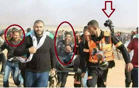 Palestinians carry their "wounded" comrade off for "treatment". April 2018, Gaza-Israel border.