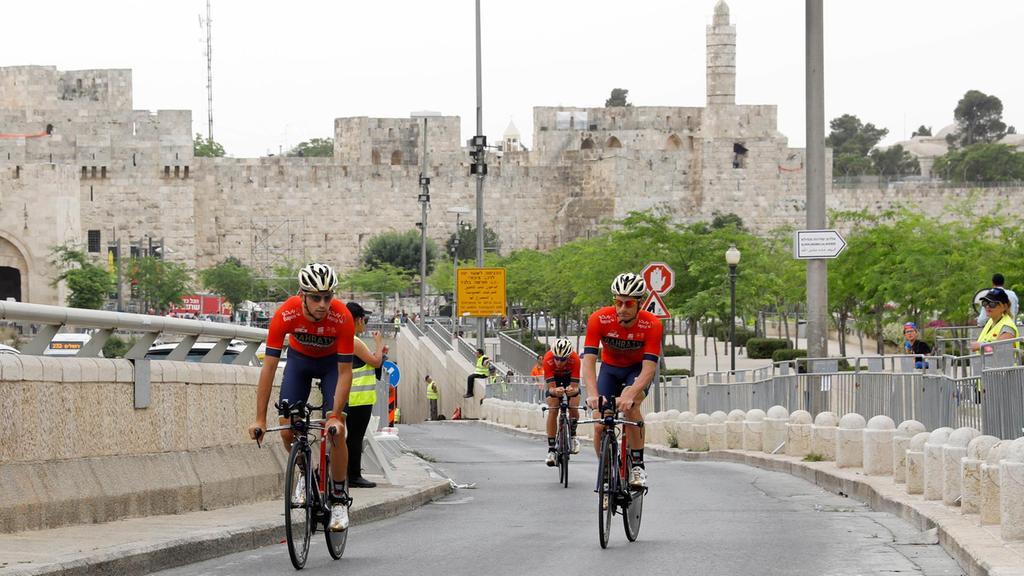 Italian cyclist Niccolo Bonifazio (R) of Bahrain Merida team and teammates warm up along the walls of Jerusalem's old city before the start of the first stage of the Giro d'Italia cycling race, a 9.7km individual time trial in Jerusalem, Israel, 04 May 2018. Abir Sultan / EPA