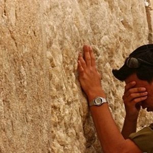 Praying at the wall (pic found on :jerusalemstone.theisraelboutique.com